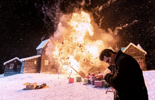 Zachary Quinto as Charlie Manx in 'NOS4A2' in front of an exploding building