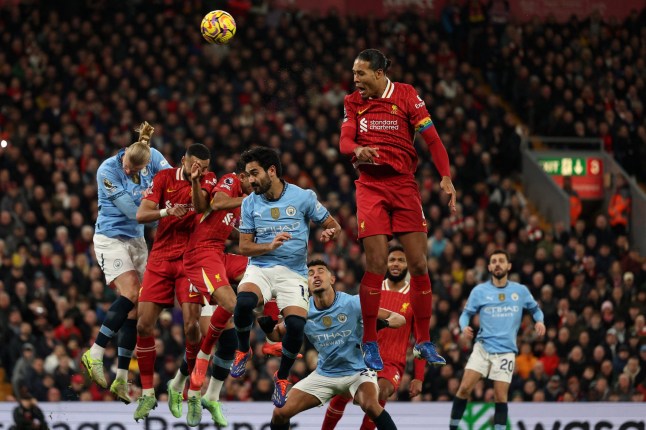 Liverpool's Dutch defender #04 Virgil van Dijk jumps to head the ball during the English Premier League football match between Liverpool and Manchester City at Anfield in Liverpool, north west England on December 1, 2024. (Photo by Adrian Dennis / AFP) / RESTRICTED TO EDITORIAL USE. No use with unauthorized audio, video, data, fixture lists, club/league logos or 'live' services. Online in-match use limited to 120 images. An additional 40 images may be used in extra time. No video emulation. Social media in-match use limited to 120 images. An additional 40 images may be used in extra time. No use in betting publications, games or single club/league/player publications. / (Photo by ADRIAN DENNIS/AFP via Getty Images)