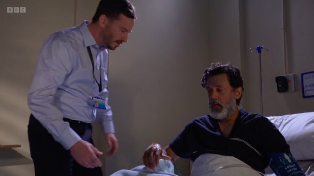 A doctor takes medical equipment off Nish Panesar in EastEnders