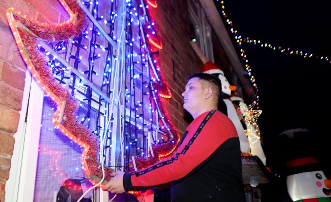 Michael Stonier outside his home in Blythe Bridge, Stoke-on-Trent, with his Christmas lights display. December 3, 2024. A family has slammed 'Scrooge' housing bosses following complaints their Christmas display is keeping residents awake and causing LIGHT POLLUTION. Each year the Stonier family turn their home into a festive winter wonderland featuring 7,000 lights and inflatables in a tradition dating back 23 years. They say delighted children flock to see the display which covers their property in Stoke-on-Trent, Staffs., after spending ??10,000 on it over the years. But Michael Stonier, 21, said he was left stunned when they got a letter from social housing bosses trying to impose restrictions on this year's lights. They said some neighbours had complained about light pollution causes by the display which was also stopping them from getting to sleep. Homes Plus Group told him they must be switched off by 10pm each night and even ordered him not to put them up too early.