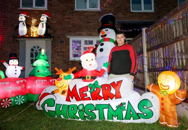 Michael Stonier outside his home in Blythe Bridge, Stoke-on-Trent, with his Christmas lights display. December 3, 2024. A family has slammed 'Scrooge' housing bosses following complaints their Christmas display is keeping residents awake and causing LIGHT POLLUTION. Each year the Stonier family turn their home into a festive winter wonderland featuring 7,000 lights and inflatables in a tradition dating back 23 years. They say delighted children flock to see the display which covers their property in Stoke-on-Trent, Staffs., after spending ??10,000 on it over the years. But Michael Stonier, 21, said he was left stunned when they got a letter from social housing bosses trying to impose restrictions on this year's lights. They said some neighbours had complained about light pollution causes by the display which was also stopping them from getting to sleep. Homes Plus Group told him they must be switched off by 10pm each night and even ordered him not to put them up too early.