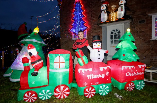 Michael Stonier outside his home in Blythe Bridge, Stoke-on-Trent, with his Christmas lights display. December 3, 2024. A family has slammed 'Scrooge' housing bosses following complaints their Christmas display is keeping residents awake and causing LIGHT POLLUTION. Each year the Stonier family turn their home into a festive winter wonderland featuring 7,000 lights and inflatables in a tradition dating back 23 years. They say delighted children flock to see the display which covers their property in Stoke-on-Trent, Staffs., after spending ??10,000 on it over the years. But Michael Stonier, 21, said he was left stunned when they got a letter from social housing bosses trying to impose restrictions on this year's lights. They said some neighbours had complained about light pollution causes by the display which was also stopping them from getting to sleep. Homes Plus Group told him they must be switched off by 10pm each night and even ordered him not to put them up too early.