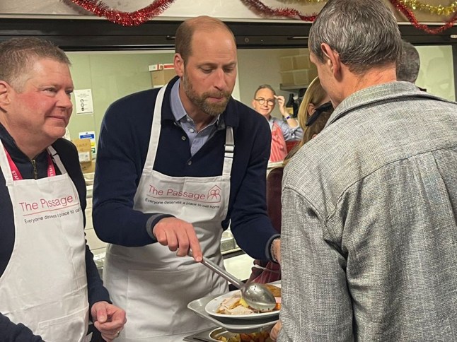 Prince William puts on apron to serve Christmas dinner at the Passage homeless charity he first visited with Princess Diana