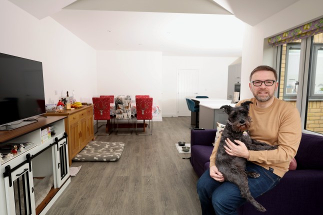 Richard Tosh with his dog liquorice at his home in St Neots Cambridgeshire. Richard and his family have recently bought the four bedroom property after returning to the UK from New Zealand.