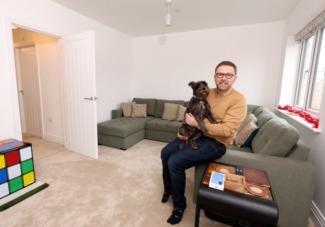 Richard Tosh with his dog liquorice at his home in St Neots Cambridgeshire. Richard and his family have recently bought the four bedroom property after returning to the UK from New Zealand.