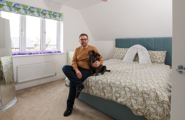 Richard Tosh with his dog liquorice at his home in St Neots Cambridgeshire. Richard and his family have recently bought the four bedroom property after returning to the UK from New Zealand.