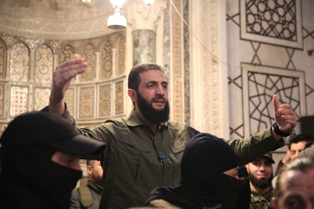 TOPSHOT - The leader of Syria's Islamist Hayat Tahrir al-Sham (HTS) group that headed a lightning rebel offensive snatching Damascus from government control, Abu Mohammed al-Jolani, address a crowd at the capital's landmark Umayyad Mosque on December 8, 2024. Jolani, now using his real name Ahmed al-Sharaa, gave a speech as the crowd chanted "Allahu akbar (God is greatest)," a video shared by the rebels on their Telegram channel showed. (Photo by Aref TAMMAWI / AFP) (Photo by AREF TAMMAWI/AFP via Getty Images) *** BESTPIX ***