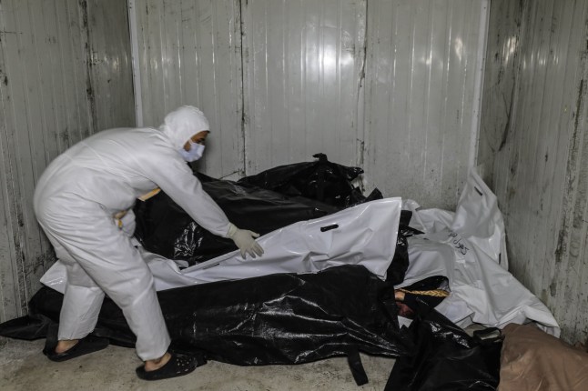 DAMASCUS, SYRIA - DECEMBER 10: (EDITOR'S NOTE: Image depicts death) A view of dead bodies, who were tortured to death, at Al-Mujtahid Hospital as teams carry out investigation in secret compartments at Sednaya Prison after the fall of the Assad regime in Damascus, Syria on December 10, 2024. Anadolu reporters in Damascus documented efforts of the Syrian Civil Defense, known as the White Helmets, as they worked to uncover the hidden chambers at the prison. Bodies were stamped with numbers on their shrouds in accordance with the codes in prisons, but without names. (Photo by Izettin Kasim/Anadolu via Getty Images)