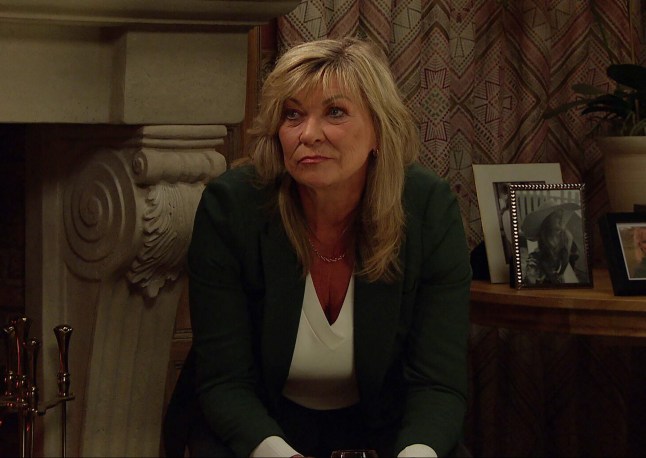 Kim Tate sits in a chair in Emmerdale