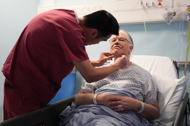 EMBARGOED TO 0001 FRIDAY DECEMBER 13 Natalie?Boller, 63, has a Genio Nyxoah bilateral hypoglossal nerve stimulator implant fitted for obstructive sleep apnoea, by Consultant ENT and Sleep Surgeon Ryan Chin Taw Cheong, at University College London Hospital (UCLH). Picture date: Wednesday December 4, 2024. PA Photo. Patients with a common sleep disorder have been fitted with an app-controlled device that zaps the nerves in the tongue to help them breathe overnight in a UK first. The technology could spell the end for uncomfortable machinery which some people need to sleep at night. See PA story HEALTH Sleep. Photo credit should read: Lucy North/PA Wire