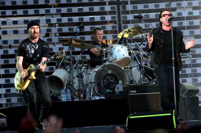 U2 members The Edge, Larry Mullen Jr and Bono performing on stage during their Vertigo tour in 2005