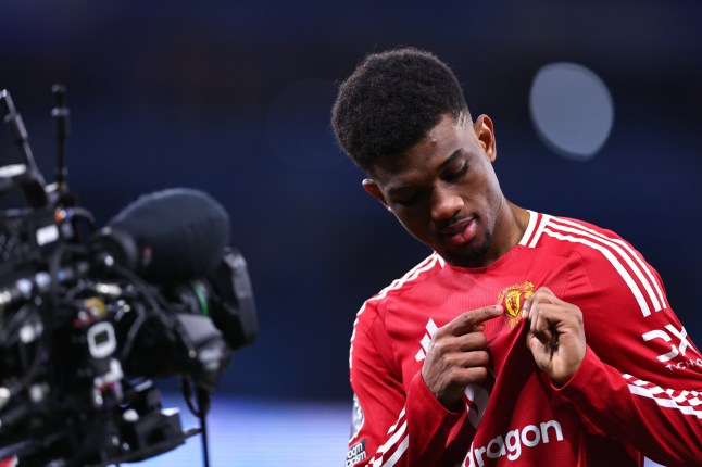 MANCHESTER, ENGLAND - DECEMBER 15: Amad Diallo of Manchester United celebrates by pointing to the Manchester United crest on his shirt at full time during the Premier League match between Manchester City FC and Manchester United FC at Etihad Stadium on December 15, 2024 in Manchester, England. (Photo by Robbie Jay Barratt - AMA/Getty Images)