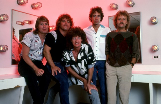 DETROIT - DECEMBER 31: (L-R) Bass guitarist Bruce Hall, lead guitarist Gary Richrath (1949-2015), rhythm guitarist and lead singer Kevin Cronin, drummer Alan Gratzer, and keyboardist Neal Doughty, all of the American rock band REO Speedwagon, pose for a portrait backstage at the Cobo Arena on December 31, 1985, in Detroit, Michigan. (Photo by Ross Marino/Getty Images)