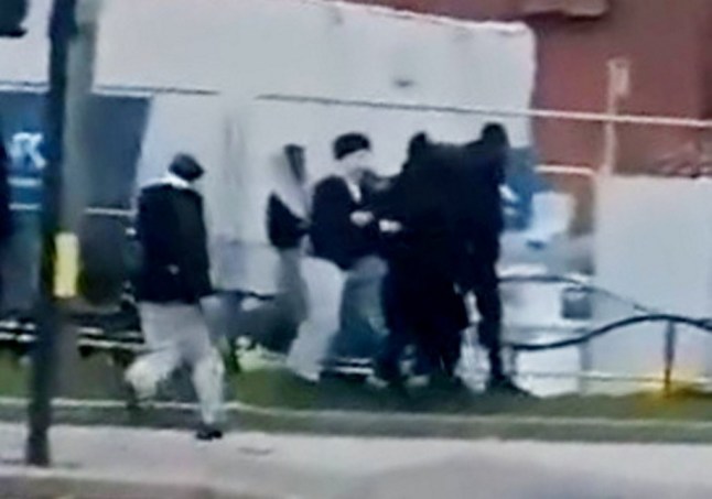 Shocking footage shows gangs of youths chasing each other armed with machetes after violence erupted outside a college. Release date ? December 18, 2024. The chaotic scenes were captured near Sandwell College, in West Bromwich, West Mids., after the yobs clashed in the street in broad daylight. Mobile phone footage shows more than a dozen hooded youths running amok in the middle of the town centre with at least two armed with massive blades. At one point, a man appears to lunge towards another with a knife narrowly missing him as stunned motorists are forced to a halt. One single college security guard can be seen running into shot as groups of people swarm the area near a shopping centre. The disturbing video was obtained by the Birmz Is Grime blog where it has been viewed thousands of times after being uploaded to social media.