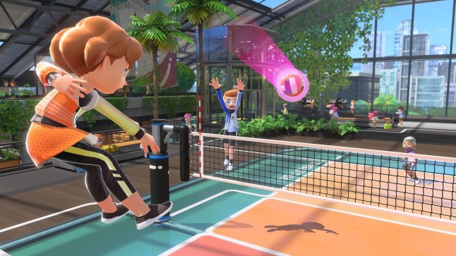 Nintendo Switch Sports character ind mid-air after spiking volleyball over net towards opponent player