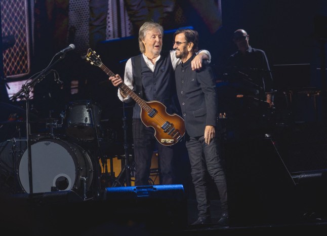 Sir Paul McCartney and Sir Ringo Starr embrace on stage