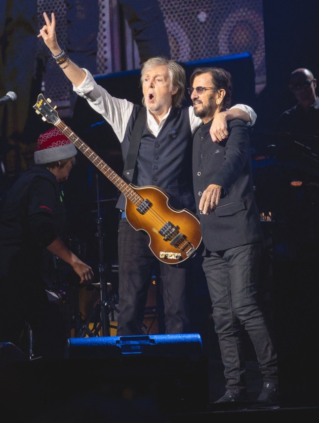 Sir Paul McCartney and Sir Ringo Starr embrace on stage