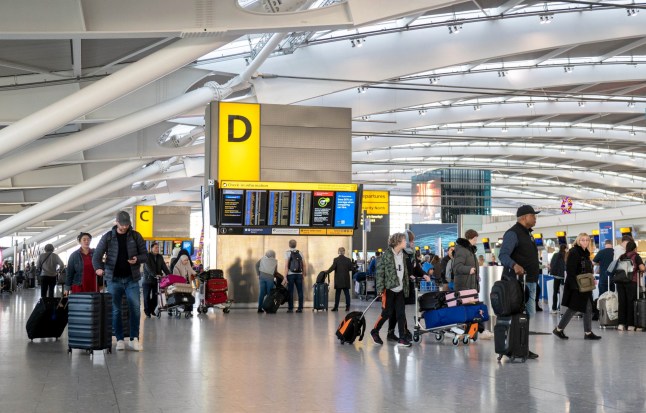 Travellers at Heathrow airport ahead of Christmas, London. December 20, 2024. Drivers are being told to prepare for "one of the busiest Christmas getaways in years". Friday is predicted to be the busiest day on the roads during the festive period, with an estimated 23.7 million drivers planning a trip, the AA said.