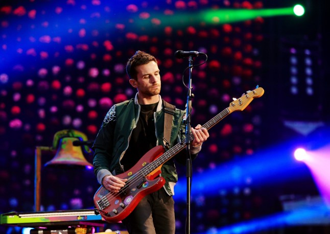 Guy Berryman from Coldplay plays guitar in concert