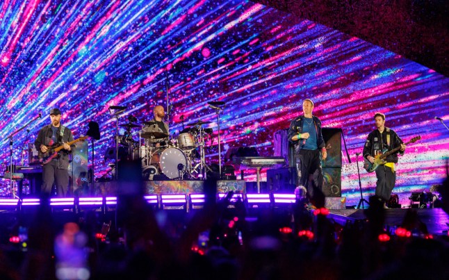 Jonny Buckland, Will Champion, Chris Martin and Guy Berryman of Coldplay perform at Eden Park in Auckland New Zealand