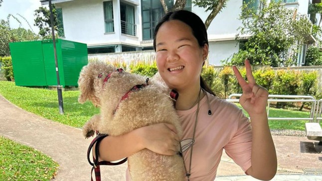 Jenna Chan pictured holding a dog.