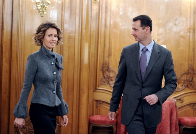 Syrian president Bashar al-Assad and his wife Asma arrive to deliver a speech for the Syrian Community on December 9, 2010 in Paris. Al-Assad is on a two-days official visit to France. AFP PHOTO MIGUEL MEDINA (Photo credit should read MIGUEL MEDINA/AFP via Getty Images)