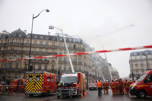 Firefighters work after a fire broke out on the top floor of a residential and office building near the busy St. Lazare train station in northwest Paris, Tuesday, Dec. 24, 2024. (AP Photo/Thomas Padilla)