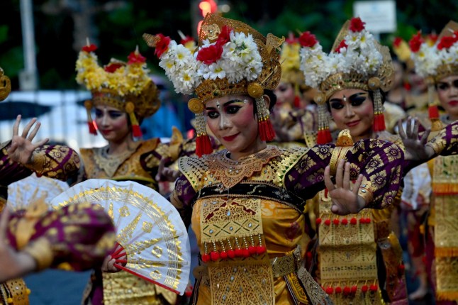 Balinese traditional dancers perform during the dance of releasing the sun 2024, welcoming the sun 2025 a New Year's Eve celebration in Denpasar on Indonesia's resort island of Bali on December 31, 2024. (Photo by SONNY TUMBELAKA / AFP) (Photo by SONNY TUMBELAKA/AFP via Getty Images)