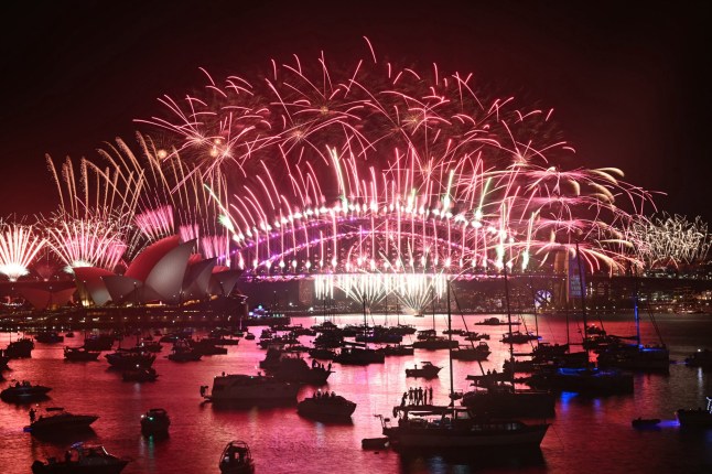 Fireworks light up the midnight sky over Sydney Harbour Bridge and Sydney Opera House during 2025 New Year's Day celebrations in Sydney on January 1, 2025. (Photo by Saeed KHAN / AFP) (Photo by SAEED KHAN/AFP via Getty Images)