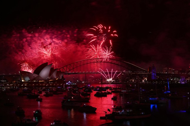 Fireworks light up the midnight sky over Sydney Harbour Bridge and Sydney Opera House during 2025 New Year's Day celebrations in Sydney on January 1, 2025. (Photo by Saeed KHAN / AFP) (Photo by SAEED KHAN/AFP via Getty Images)