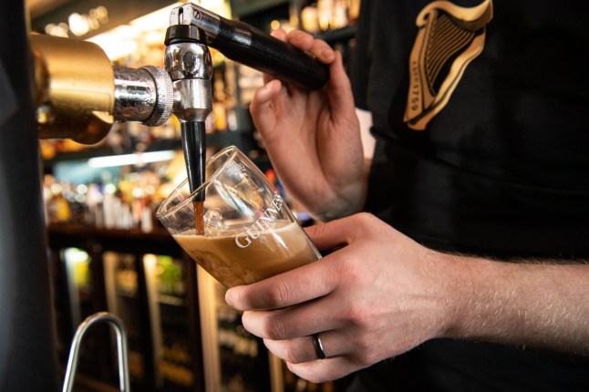 EDITORIAL USE ONLY Landlord, David Finan pours a pint of Guinness at The Raven in London, as the pub prepares to welcome customers back inside and reopen its doors today following the latest easing of the government's Covid-19 lockdown measures. PA Photo. Issue date: Monday May 17, 2021. Photo credit should read: Jeff Spicer/PA Wire