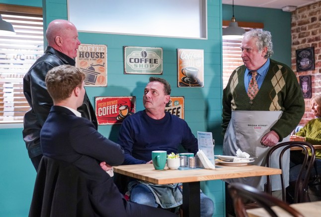 Phil approaches Nigel, Billy and Jay in the cafe in EastEnders