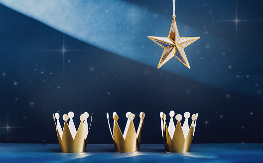 three shiny crowns and a star. Epiphany and three kings day night