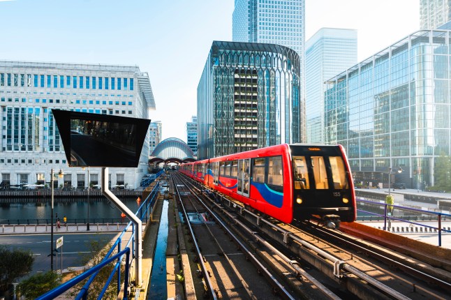 DLR train riding through Canary Wharf in London