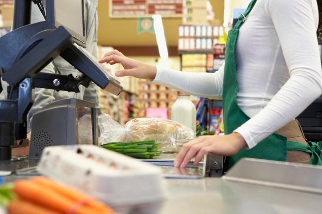 Cashier ringing up groceries in a supermarket