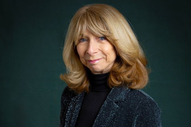 Coronation Street actress Helen Worth in front of a deep green background