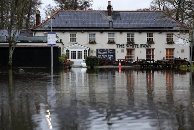 Water covers the flooded car park of the White Swan pub after the River Itchen burst it's banks following torrential rain, near Eastleigh, southern England, on January 2025. (Photo by Adrian Dennis / AFP) (Photo by ADRIAN DENNIS/AFP via Getty Images)