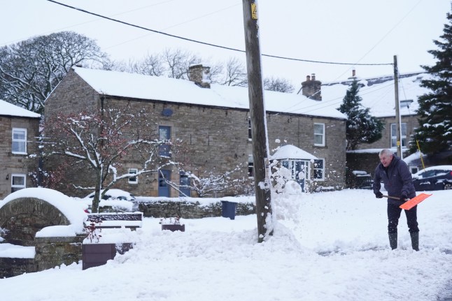 A man clears snow in Catton, Northumberland. Weather warnings remain in force across much of the UK on Monday with adverse conditions, including flooding from heavy rain and thawing snow. Picture date: Monday January 6, 2025. PA Photo. Photo credit should read: Owen Humphreys/PA Wire