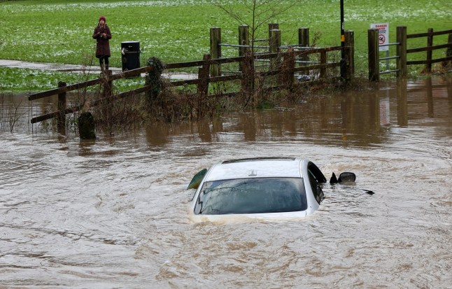 Stranded car in flood water at Green Road in Hall Green Birmingham today. The River Cole is flooded after snow and rain. January 6 2025.