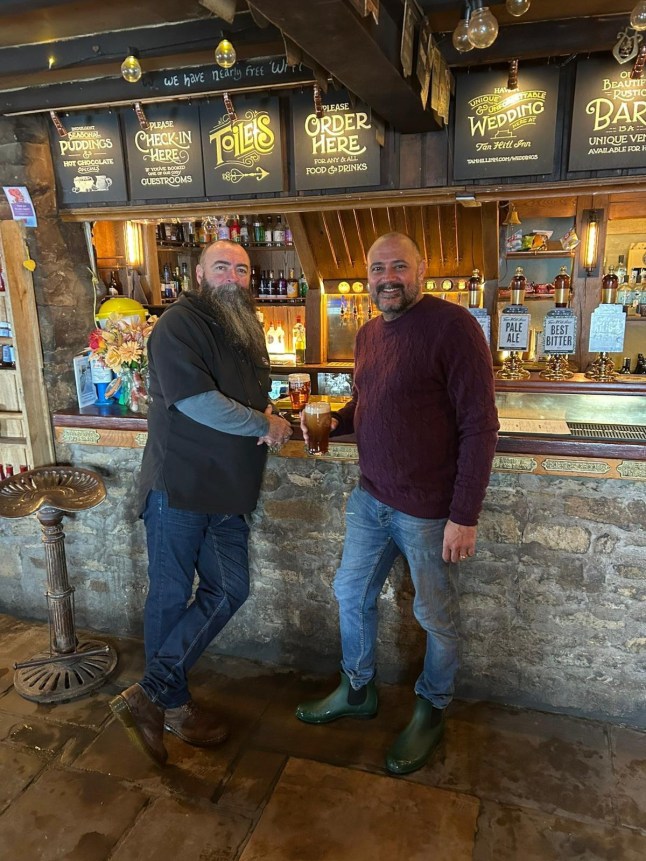 From left: Paul Wright another snowed-in visitor at the Tan Hill Inn in North Yorkshire. Release date January 6 2025. More than 30 people are currently snowed in at Britain's highest pub after an Arctic blast swept across the UK. Customers who had trekked to Tan Hill Inn in North Yorkshire - which is is 528 metres (1,732 ft) above sea level - were today (Mon) still holed up in the world famous boozer. Despite amber warnings of snow, 32 guests attended the pub on Saturday night and have remained cut off ever since, along with six staff who were on duty. It comes as temperatures fell to -11.1C in some parts and the Met Office and UK Health Security Agency issued amber "danger to life" alerts ahead of the blizzards.