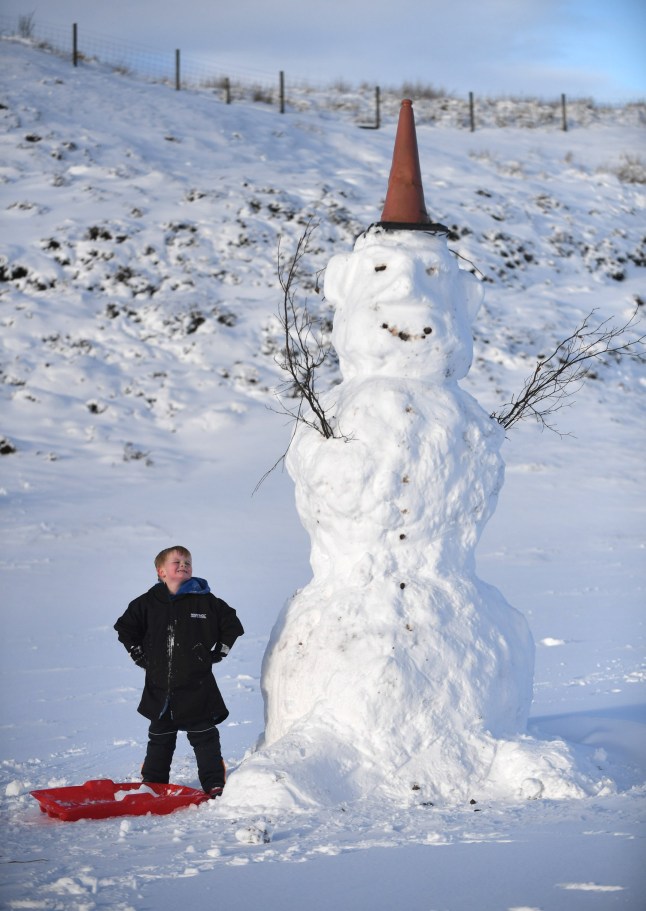 Aaden Campbell, 5, puts the finishing touches to a giant snowman in the village of Wanlockhead, Dumfries and Galloway, Scotland, which claims to be the highest village in Scotland as Met office snow warnings hit Scotland. January 6, 2026. In Leadhills and the nearby village of Wanlockhead, which also claims the crown of being highest village in Scotland, snow was as deep as 10 inches and earlier this morning before a gritter arrived the roads were difficult to drive according to locals. Schools are off so it?s hard to assess if school would have closed.