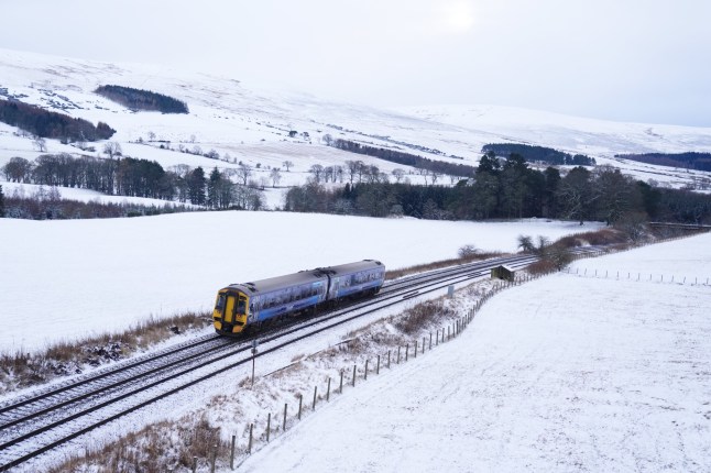 A ScotRail train in snowy conditions near Gleneagles in Perthshire. Weather warnings remain in force across much of the UK on Monday with adverse conditions, including flooding from heavy rain and thawing snow. Picture date: Monday January 6, 2025. PA Photo. Photo credit should read: Andrew Milligan/PA Wire