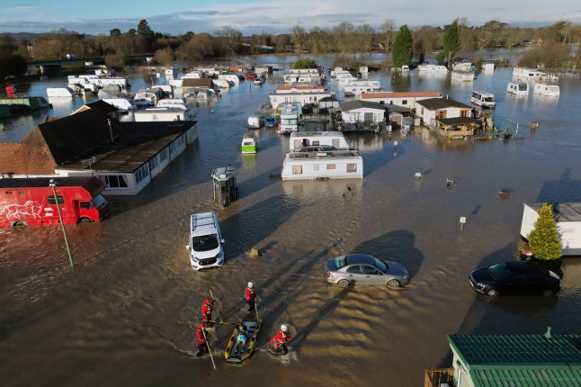 A man is rescued from the flooding at a caravan park near Barrow upon Soar, Leicestershire. Weather warnings for snow and ice are in force across much of the UK after severe flooding and snow caused travel disruption and school closures. Across England, there are also 198 flood warnings, meaning flooding is expected, and 300 flood alerts, meaning flooding is possible. Picture date: Tuesday January 7, 2025. PA Photo. Photo credit should read: Joe Giddens/PA Wire