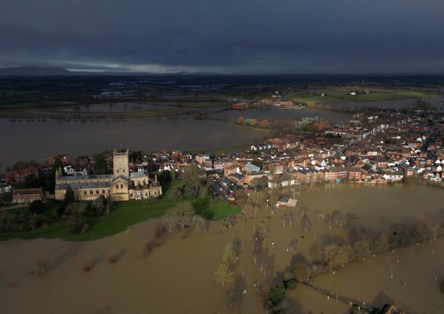 A drone view shows floodwater around Tewkesbury Abbey as rain clouds gather in the distance, in Tewkesbury, Britain, January 7, 2025. REUTERS/Toby Melville