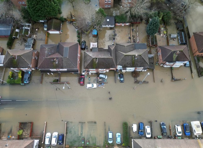 Homes stand in flood water after the Grand Union Canal burst its banks in Loughborough, England, Tuesday, Jan. 7, 2025. (AP Photo/Darren Staples)