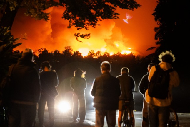 People watch the smoke and flames from the Palisades Fire