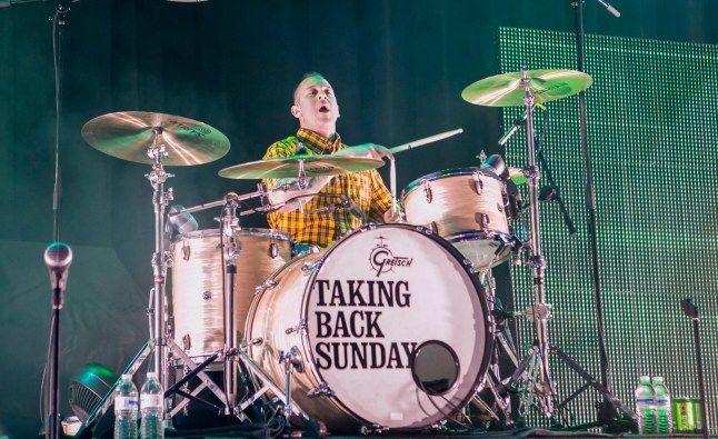 Mark O'Connell of Taking Back Sunday performs on stage behind drum kit