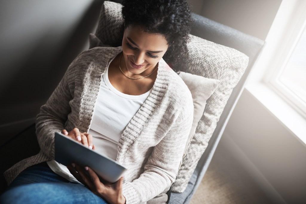 a young woman enjoying shopping online with her tablet thanks to efficient product optimization