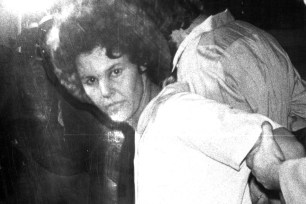 Judith Clark is led by authorities in 1981.