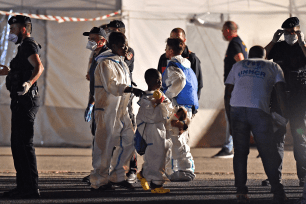 Migrants disembark from the Italian Coast Guard vessel "Diciotti" at the port of Pozzallo, Sicily on June 19.